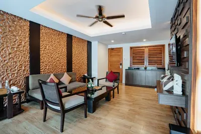 a living room with a couch and a ceiling fan at Villa Kayu Raja in Seminyak