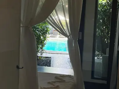 a room with a window with a view of a pool at Pearl Boutique Hotel Adult only in Legian