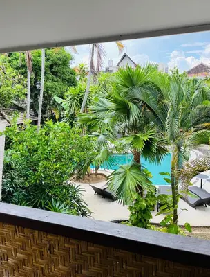 a view from a window of a resort with palm trees at Pearl Boutique Hotel Adult only in Legian