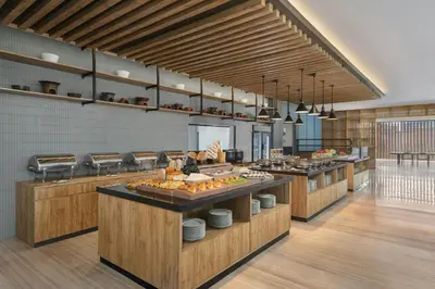 a large kitchen with a bunch of food at Fairfield by Marriott Bali Kuta Ngurah Rai in Kuta