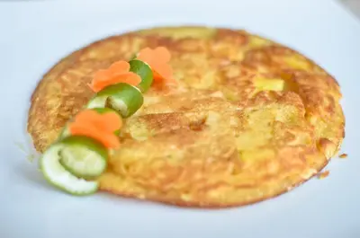 a close up of a pie with vegetables on it at Palm Bamboo Hotel in Nusa Dua