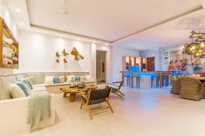 a living room with a couch and a table at Villa Smilla in Seminyak