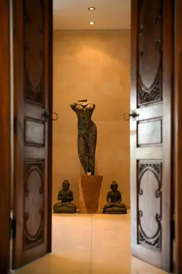 a statue in a room with two statues in a doorway at Villa Zanissa in Seminyak