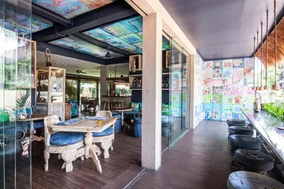 a room with a ping pong table and glass walls at Blue Karma Dijiwa Seminyak in Seminyak