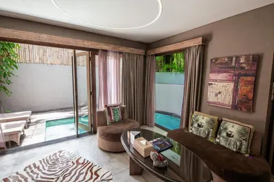 a living room with a couch and a table at Blue Karma Dijiwa Seminyak in Seminyak