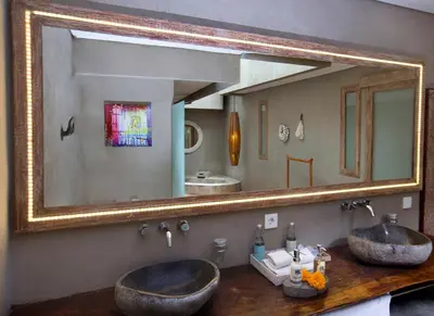 a bathroom with two sinks and a large mirror at Blue Karma Dijiwa Seminyak in Seminyak