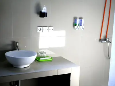 a bathroom with a white sink on a counter at Vivaldi Jimbaran in Jimbaran