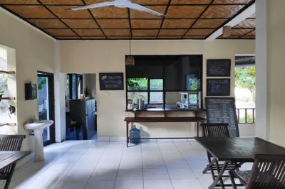 a restaurant with a table and chairs and a counter at Villa Puri Royan Jimbaran in Jimbaran