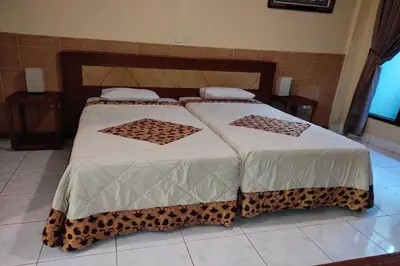 two beds in a bedroom with leopard print at Villa Puri Royan Jimbaran in Jimbaran