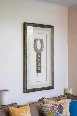 a framed picture of a key on a wall above a couch at Private 2 Bed Pool Villa in Bustling Petitenget in Seminyak