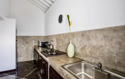 a kitchen with a sink and a vase on the counter at Villa JULIA | heart of Seminyak | 350m Beach in Seminyak