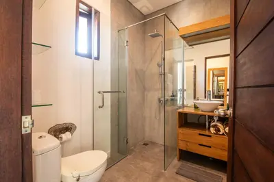 a bathroom with a shower and a toilet and a sink at Villa Alissa in Seminyak