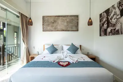 a bedroom with a bed with towels on it at Villa Alissa in Seminyak