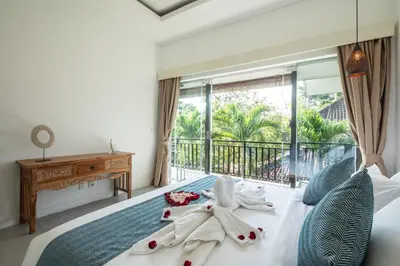 a bedroom with a bed with towels on it at Villa Alissa in Seminyak