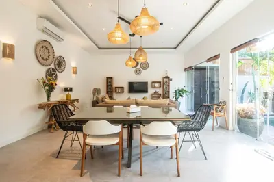 a dining room with a table and chairs at Villa Alissa in Seminyak