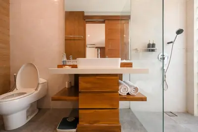 a bathroom with a sink and a toilet at The Wina Villa Seminyak by The Wina Resorts in Seminyak