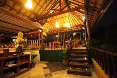 a restaurant with a staircase in the middle of a building at Sanur Seaview Hotel in Sanur