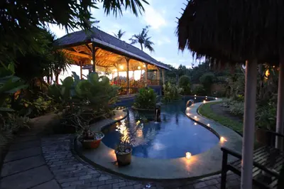a resort with a pool and a building with lights at Sanur Seaview Hotel in Sanur