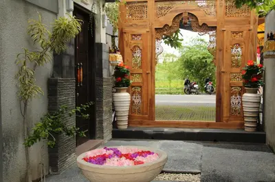 a large bowl of flowers sitting in front of a door at The Nakula Villas in Legian