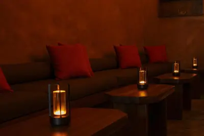 a living room with a couch and two tables with candles at Villa Air Bali Boutique Resort and Spa in Seminyak