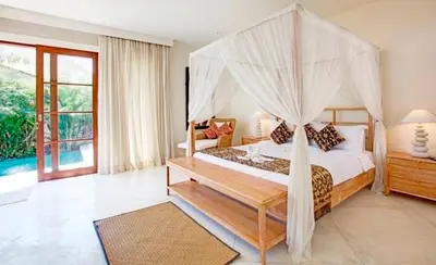 a bedroom with a bed with a canopy at Villa Sahaja in Canggu