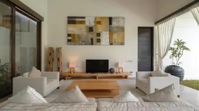 a living room with a couch and a tv at Villa Alice by Villa Finder in Seminyak