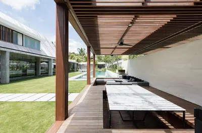 a wooden deck with benches on the side of a building at Villa Keila Seminyak in Seminyak