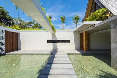 an external view of a house with a swimming pool at Villa Keila Seminyak in Seminyak