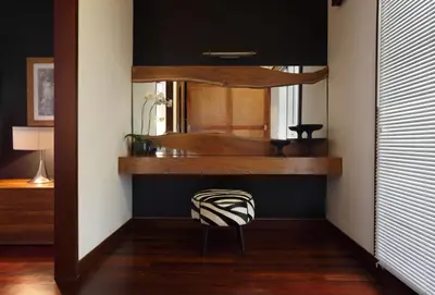 a room with a mirror and a chair in a room at The One Boutique Villa & Spa Seminyak in Seminyak