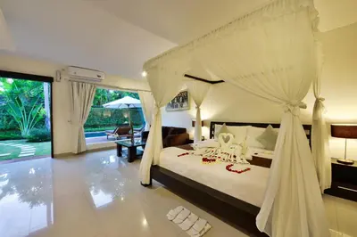 a bedroom with a bed with a canopy at The Yubi Boutique Villas Seminyak in Seminyak