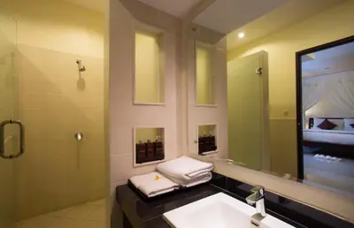 a bathroom with a sink and a mirror at The Yubi Boutique Villas Seminyak in Seminyak