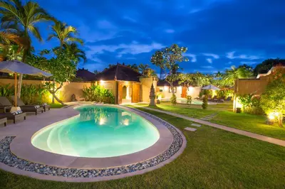 a swimming pool in the yard of a house at Bali Dyana Villas in Seminyak