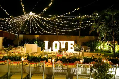 a table with lights and a sign that says love at Bali Dyana Villas in Seminyak