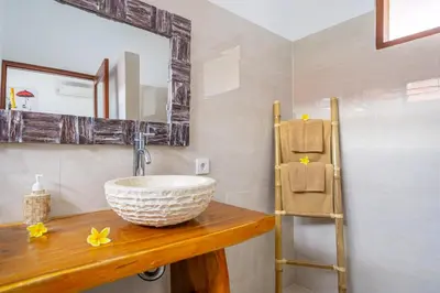 a bathroom with a sink and a mirror at Villa Jimmy in Seminyak