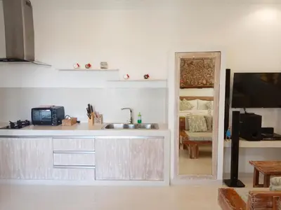 a kitchen with a sink and a tv in a room at ★ VIP ★ Green Studio Apartment in Seminyak, No.23 in Seminyak