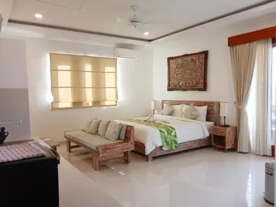 a bedroom with a bed and a chair and a window at ★ VIP ★ Green Studio Apartment in Seminyak, No.23 in Seminyak