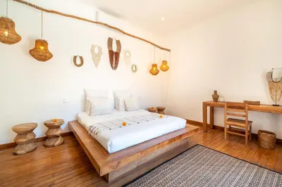 a bedroom with a bed with a wooden floor at Villa Makasih by Villa Finder in Seminyak