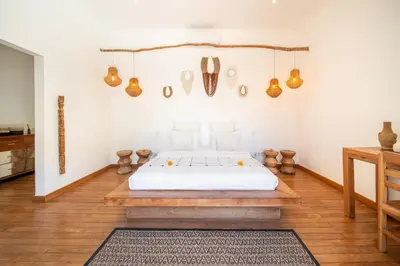 a bedroom with a bed and a wooden floor at Villa Makasih by Villa Finder in Seminyak