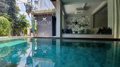 a swimming pool in front of a store with a window at Stellar Capsules in Seminyak