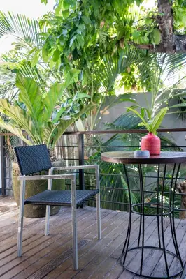 two chairs and a table and a table and a chair at Balissimo Suites Seminyak by Betterplace in Seminyak