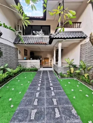 a garden outside a house with a walkway at Kumpul Kumpul Villa Seminyak - CHSE Certified in Seminyak