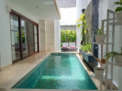 a swimming pool in the middle of a house at Villa Harmony - Residence in Seminyak