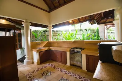 a kitchen with a stove top oven in a room at Bali Royal Heritage Villas in Seminyak