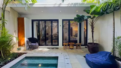 a house with a swimming pool in the middle of a courtyard at Villa Bugis Kayu Aya Seminyak in Seminyak