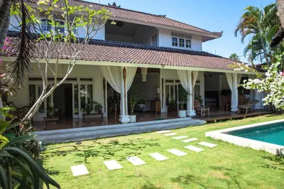 a house with a pool and a yard at Villa Jalun in Seminyak