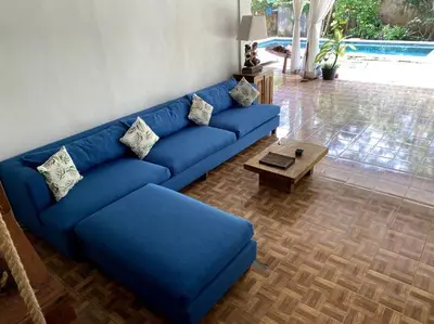 a blue couch in a living room with a coffee table at Villa Jalun in Seminyak