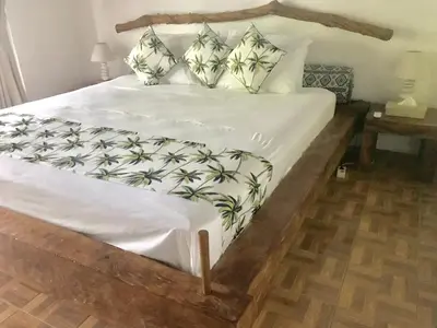 a bedroom with a large bed with white sheets and pillows at Villa Jalun in Seminyak