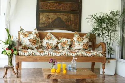 a couch in a living room with a table at Villa Jalun in Seminyak
