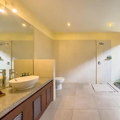 a bathroom with a sink and a toilet at Villa Bugis Drupadi Seminyak in Seminyak