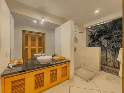 a bathroom with a sink and a shower at Villa Bugis Drupadi Seminyak in Seminyak